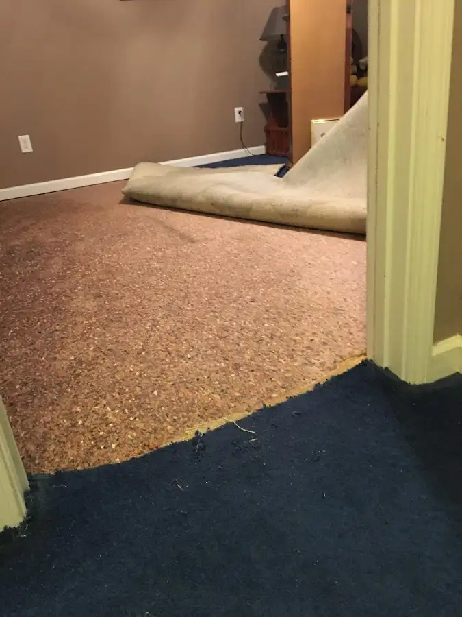 Carpet pad removal revealing water damage during Drying & Dehumidification in Ammon